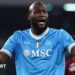 Romelu Lukaku in Napoli's light blue shirt, with raised arms held out in front of him