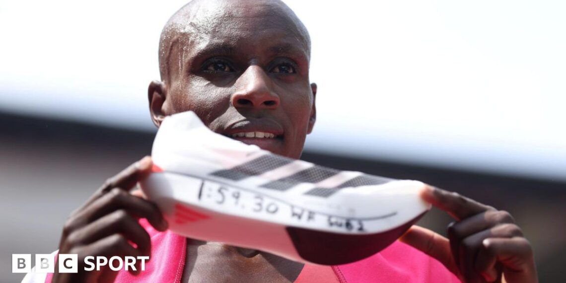Sabastian Sawe holds up the Adidas supershoe which he wore in breaking the marathon world record in London