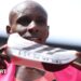 Sabastian Sawe holds up the Adidas supershoe which he wore in breaking the marathon world record in London
