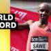 Sebastian Sawe holds up red flag behind his back after winning the 2026 London Marathon