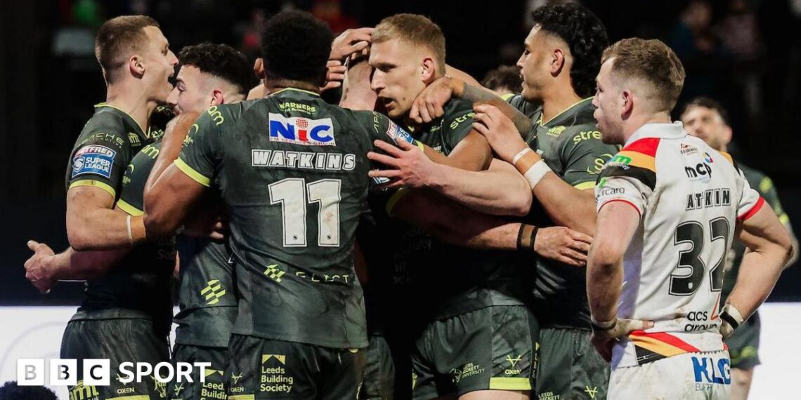 James McDonnell of Leeds celebrates with team-mates after scoring a try