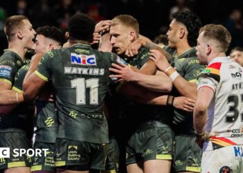James McDonnell of Leeds celebrates with team-mates after scoring a try