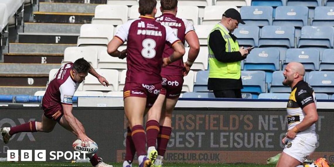 Adam Clune of Huddersfield scores a try