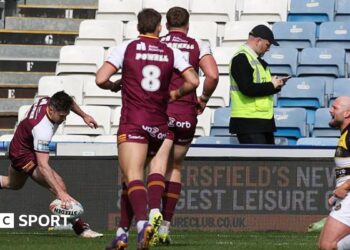 Adam Clune of Huddersfield scores a try