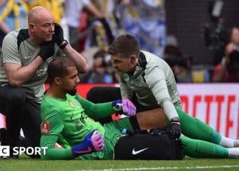 Robert Sanchez receives treatment for an apparent injury during the FA Cup semi-final between Chelsea and Leeds United at Wembley Stadium