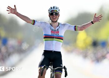 Tadej Pogacar holds his hands out wide as he celebrates winning the 2026 Tour of Flanders