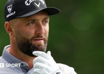 Jon Rahm with his hand on his chin