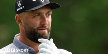 Jon Rahm with his hand on his chin