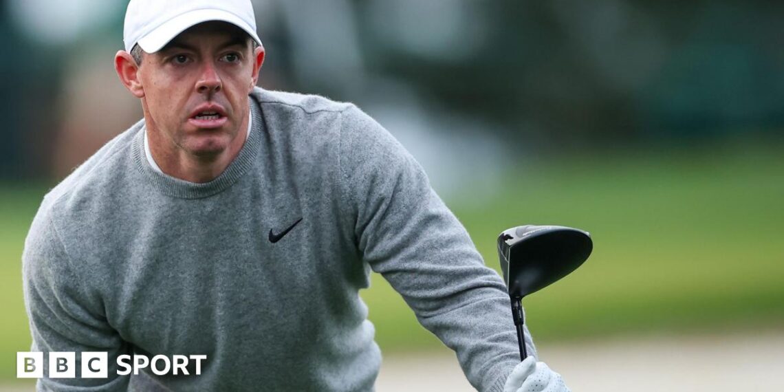 Rory McIlroy looks for his ball after hitting a tee shot