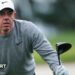 Rory McIlroy looks for his ball after hitting a tee shot