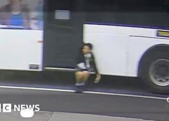 Trapped boy dangles from moving bus in Australia