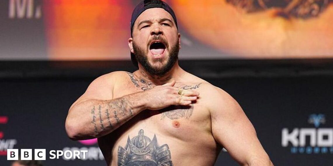 Louie Sutherland slaps his chest as he weighs in