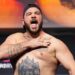 Louie Sutherland slaps his chest as he weighs in