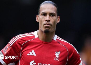 Liverpool captain Virgil van Dijk looks on as he stands with his hands resting on his hips after Liverpool's FA Cup defeat by Manchester City