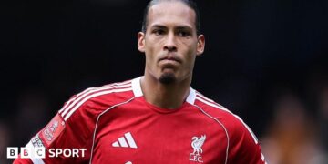 Liverpool captain Virgil van Dijk looks on as he stands with his hands resting on his hips after Liverpool's FA Cup defeat by Manchester City