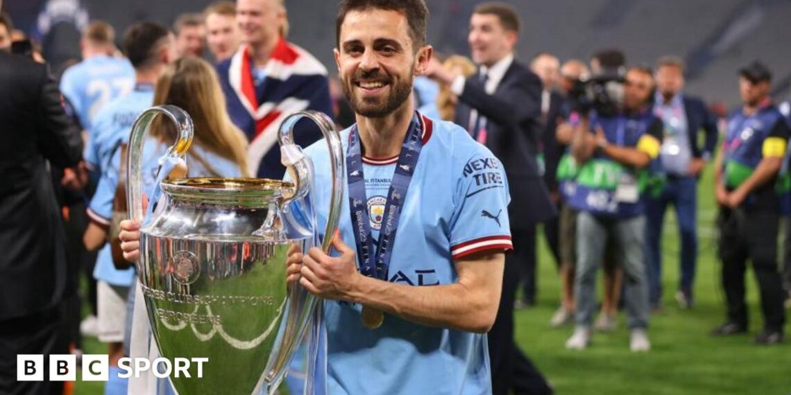 Bernardo Silva holds the Champions League trophy