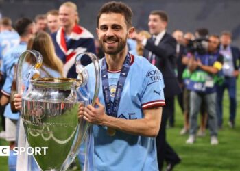 Bernardo Silva holds the Champions League trophy