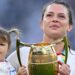 Lark Atkin-Davies and Abbie Ward with children on the Allianz Stadium pitch
