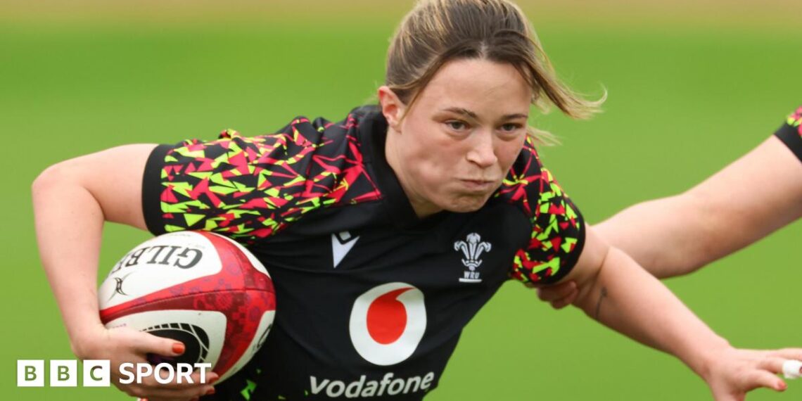 Alisha Joyce with ball under right arm runs forward in Wales training