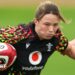 Alisha Joyce with ball under right arm runs forward in Wales training