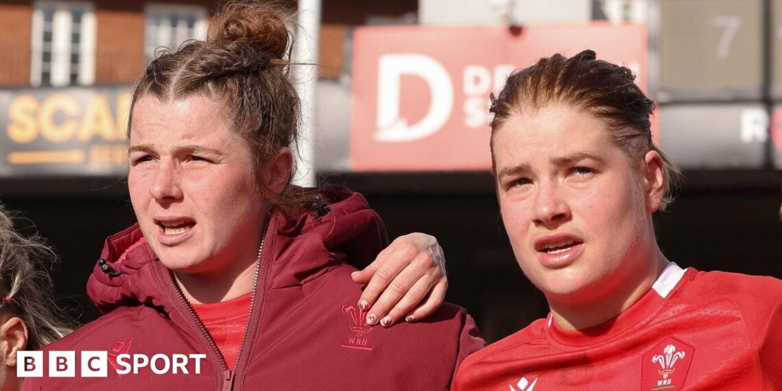 Kate Williams and Bethan Lewis in a team huddle
