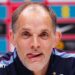 Head and shoulders view of England head coach Thomas Tuchel at a news conference, with his tongue poking out of his mouth