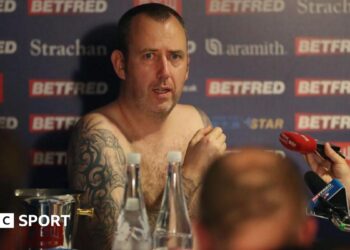 Mark Williams naked surrounded by microphones after winning his third world title in 2018
