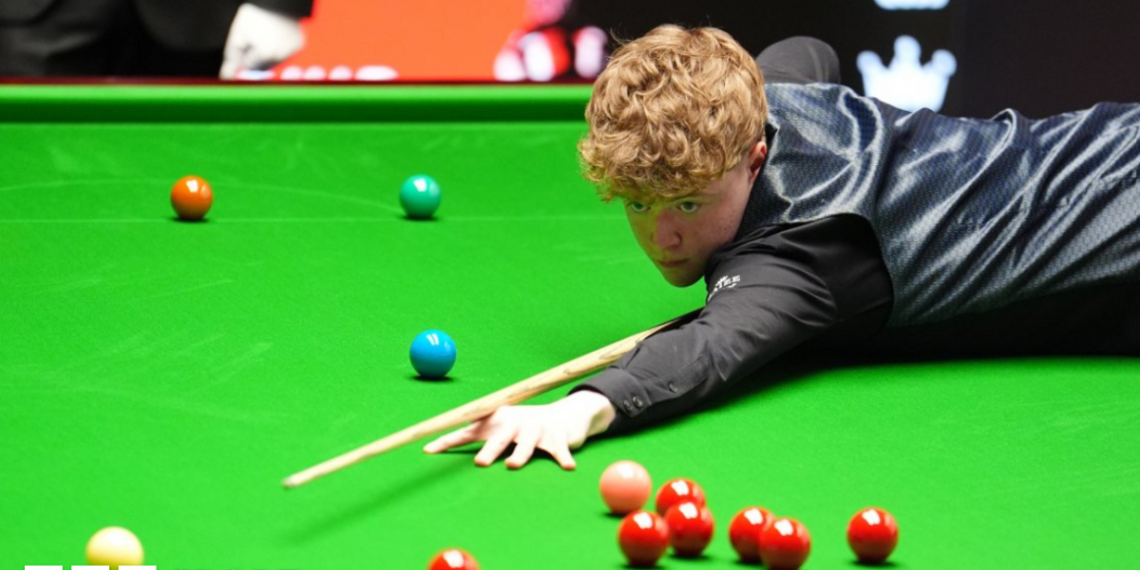 Stan Moody stretches over the snooker table to play a shot