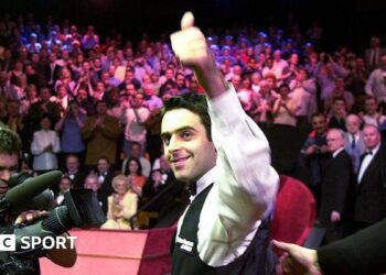 Ronnie O'Sullivan smiles and celebrates with a thumbs-up gesture after winning the 2001 World Championship