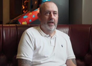 Mark Williams seated on a sofa