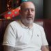Mark Williams seated on a sofa