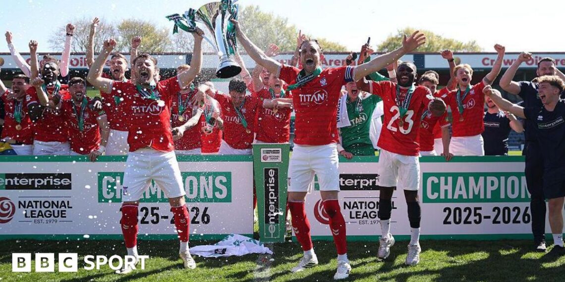 Ollie Pearce and Callum Howe of York City lift the National League Trophy after the 1-1 draw at Rochdale