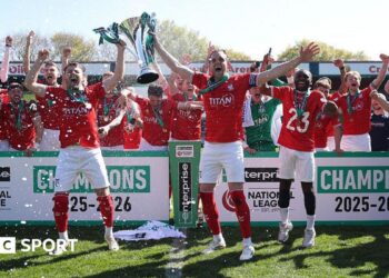 Ollie Pearce and Callum Howe of York City lift the National League Trophy after the 1-1 draw at Rochdale