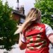 Female Arsenal fan with 'Champions 26' on the back of her shirt