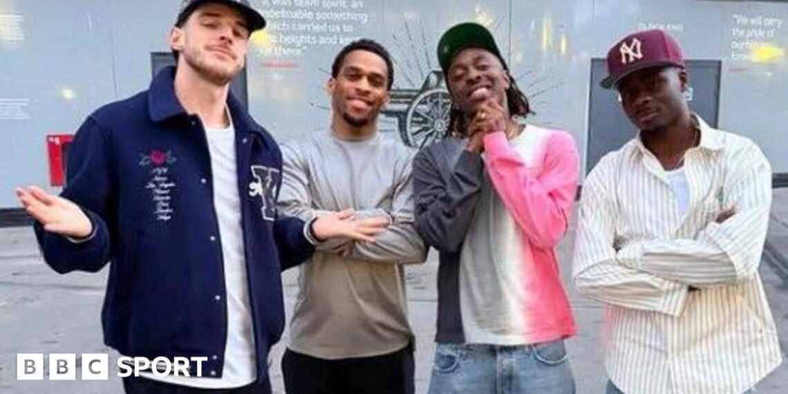 Arsenal players pose with a cutout of the Premier League trophy