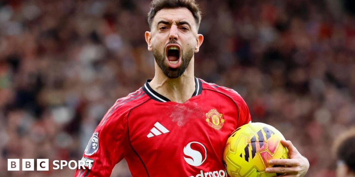 Bruno Fernandes celebrates a goal for Manchester United, with his mouth wide open and the ball in his left hand