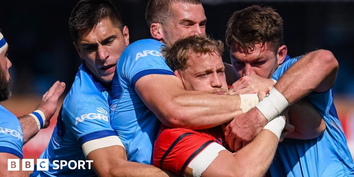 Mike Haley is tackled by the Bulls