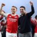 Leandro Trossard and Mikel Arteta celebrating on the Emirates Stadium pitch after beating Atletico Madrid.