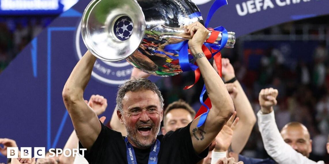 Paris St-Germain manager Luis Enrique smiling with the Champions League trophy