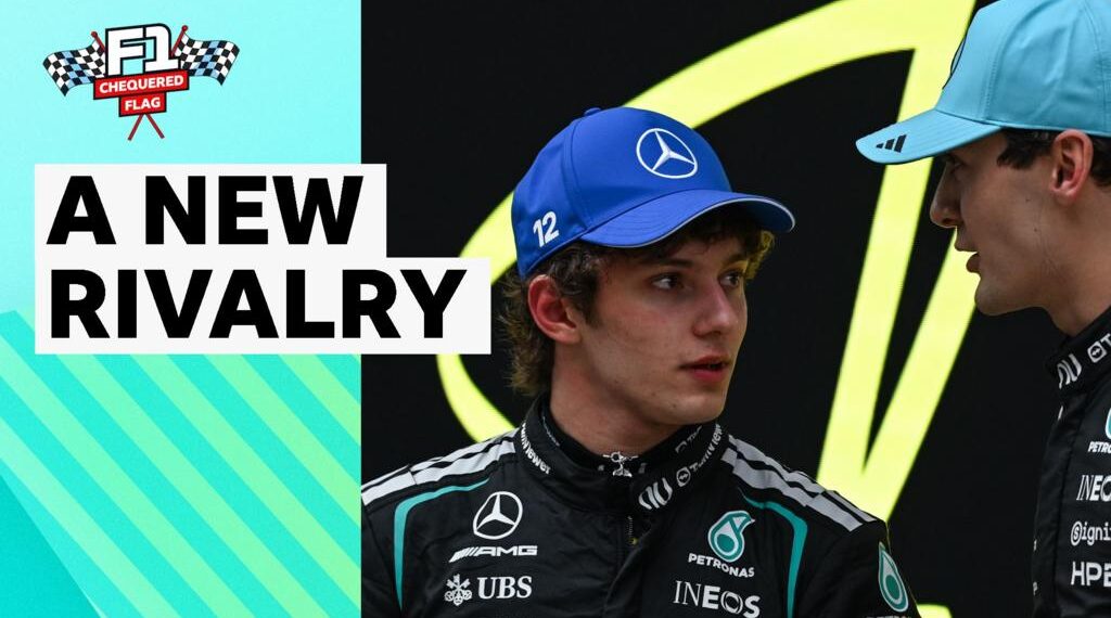 Andrea Kimi Antonelli and George Russell look towards each other wearing Mercedes race suits