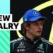 Andrea Kimi Antonelli and George Russell look towards each other wearing Mercedes race suits