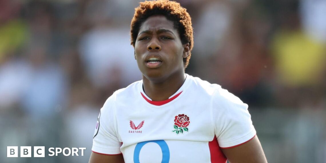 Christiana Balogun standing on the pitch wearing England kit during the Women's Six Nations game against Italy