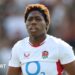 Christiana Balogun standing on the pitch wearing England kit during the Women's Six Nations game against Italy