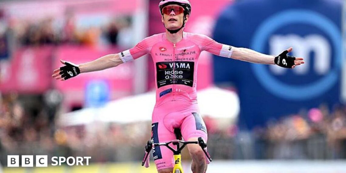 Jonas Vingegaard raises his arms as he crosses the finish line