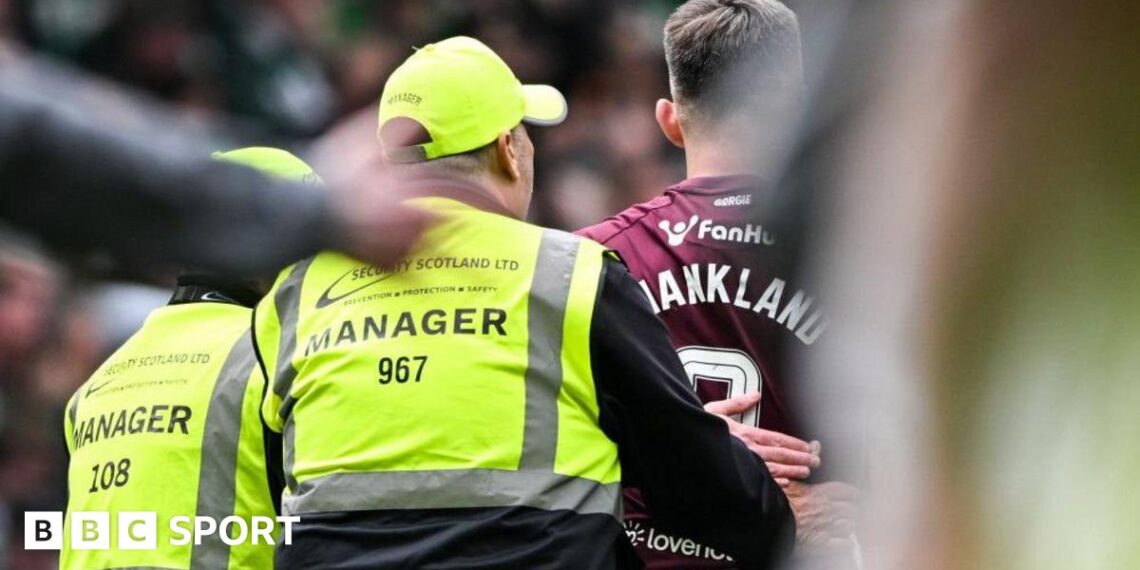 Hearts' Lawrence Shankland with stewards at full time during a William Hill Premiership match between Celtic and Heart of Midlothian at Celtic Park, on May 16, 2026, in Glasgow, Scotland.