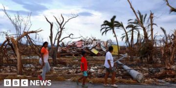 How do hurricanes and typhoons form and is climate change making them stronger?