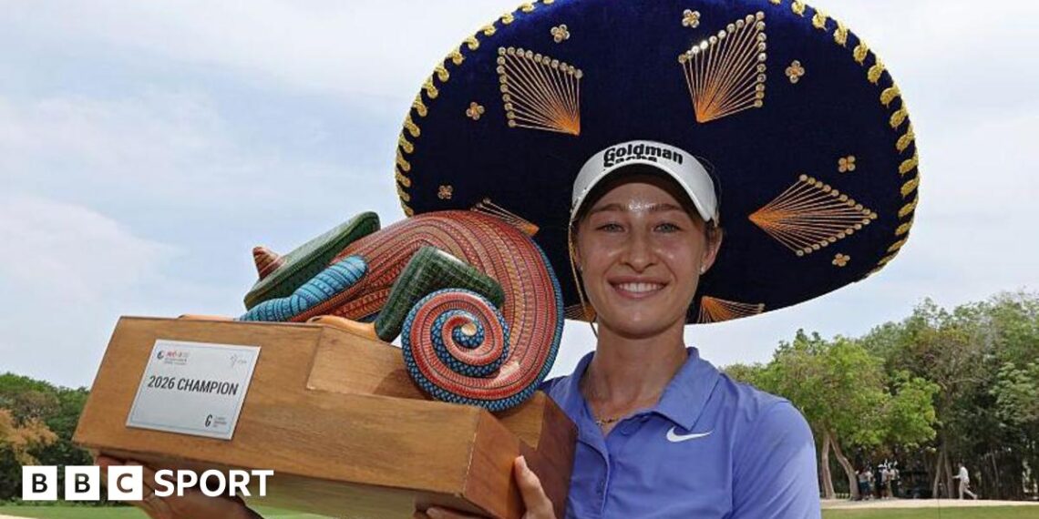 Nelly Korda celebrates winning the Riviera Maya Open in Mexico, wearing a traditional large Mexican hat and blue golf shirt, smiling, and holding a colourful trophy