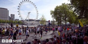 London Marathon runners with the London Eye in the background