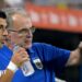 Marcelo Bielsa pointing while standing on the sidelines with Luis Suarez
