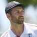Mark Wood, wearing a blue England cap, looks to the side